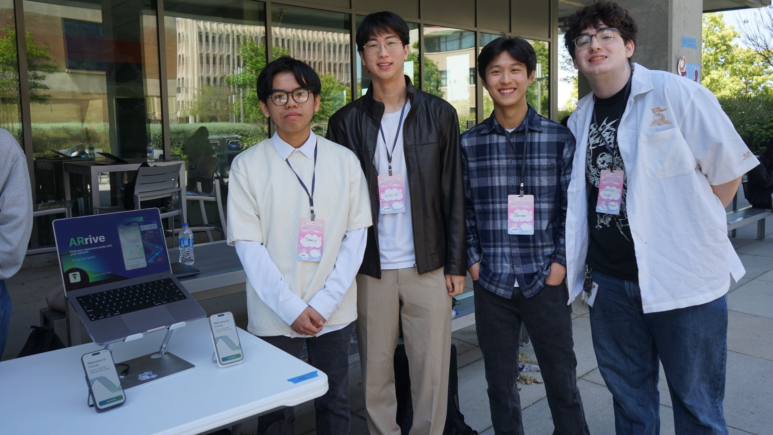 Group photo of ARrive designers next to a stand for product demos